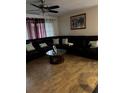 Inviting living room with tile flooring, modern ceiling fan, and a comfortable, oversized sectional sofa at 2800 Sunset Nw Dr, Winter Haven, FL 33881