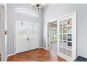 Bright foyer with decorative wood flooring, double front doors and french doors to the office at 2861 Pond View Dr, Haines City, FL 33844