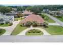 Beautiful home featuring an inviting circular driveway and lush green lawn at 328 Hamilton Shores Ne Dr, Winter Haven, FL 33881