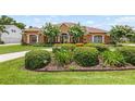 Charming front exterior showcasing manicured landscaping and inviting curb appeal at 328 Hamilton Shores Ne Dr, Winter Haven, FL 33881