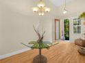 Inviting foyer featuring a unique glass table and chandelier, creating a warm ambiance at 4105 Limerick Dr, Lake Wales, FL 33859