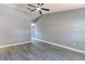 Spacious room with gray walls, white trim, wood-look floors, and a ceiling fan at 411 Red Hawk Loop, Winter Haven, FL 33880