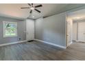 Bright entryway with gray walls, white trim, wood-look floors, and a ceiling fan at 411 Red Hawk Loop, Winter Haven, FL 33880