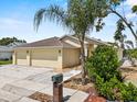Well-maintained home featuring a spacious three car garage, lush landscaping, and charming curb appeal at 452 Lake Suzanne Dr, Lake Wales, FL 33859