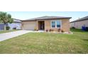 Inviting single-Gathering home with a green lawn and simple, pleasing landscaping at 4662 Osprey Way, Winter Haven, FL 33881