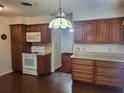 Traditional kitchen with wood cabinets, light countertops, and white appliances offering a classic aesthetic at 514 7Th S St, Dundee, FL 33838