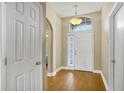 Bright foyer with hardwood flooring and a large window above the front door at 5424 Moon Valley Dr, Lakeland, FL 33812
