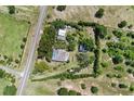 Aerial view showcases the property layout, perimeter trees, and outbuildings at 836 S Lake Starr Blvd, Lake Wales, FL 33898