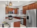 Modern kitchen with stainless steel appliances, granite countertops, and ample cabinet space at 8720 Micmac Ct, Polk City, FL 33868