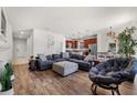 Bright, open-concept living space with hardwood floors connecting to the kitchen at 8720 Micmac Ct, Polk City, FL 33868
