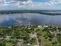 Expansive aerial view of a lakeside property showcasing its prime location and water access at 914 Mangham Rd, Babson Park, FL 33827