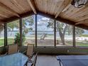 Bright sunroom with expansive windows offering stunning lake views and dock access at 914 Mangham Rd, Babson Park, FL 33827