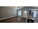 Open-concept living area featuring vaulted ceilings, wood flooring, and natural light at 1318 Herschell St, Lakeland, FL 33815