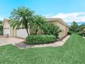 Single Gathering home with a well-manicured lawn, brick pavers, and colorful landscaping at 1349 Innsbruck Ct, Winter Haven, FL 33884