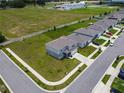 Aerial view of a two-story home featuring a well-manicured lawn and gray color scheme at 137 Piave St, Haines City, FL 33844