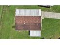 An aerial view showcases the roof and landscaping of the home at 1548 Longbow Dr, Lakeland, FL 33810