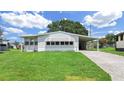 Quaint one-story home features a neatly kept lawn and convenient carport at 1548 Longbow Dr, Lakeland, FL 33810