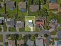 Aerial view of a residential property with a green lawn, surrounded by neighboring homes at 165 Lagoon Rd, Winter Haven, FL 33884