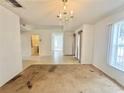 Open-concept living area with tile and carpeted flooring, and laundry access at 1844 Emily Dr, Winter Haven, FL 33884