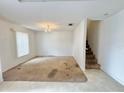 Bright living room area with staircase and chandelier at 1844 Emily Dr, Winter Haven, FL 33884