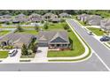 Aerial view of a single-Gathering home on a corner lot with mature trees and well-maintained landscaping at 195 Kissengen Park Blvd, Bartow, FL 33830