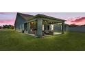 Covered back patio complete with outdoor seating, bar, and string lights, perfect for entertaining at 195 Kissengen Park Blvd, Bartow, FL 33830