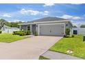 Attractive home with well-kept lawn, gray siding and a two car garage at 1976 Harvest Landing Cir, Lakeland, FL 33810