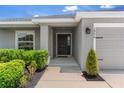 Inviting front entrance with a well-kept lawn and a black front door at 1976 Harvest Landing Cir, Lakeland, FL 33810