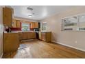 Functional kitchen featuring wooden cabinets, hardwood floors, and stainless steel appliances, providing a warm space at 208 Lake Dale Dr, Auburndale, FL 33823