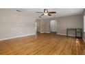 Bright living room showcasing hardwood floors, neutral paint, an open layout, and a ceiling fan at 208 Lake Dale Dr, Auburndale, FL 33823