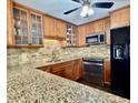 Updated kitchen featuring granite countertops, stainless steel appliances, and tile backsplash at 217 Shore Loop, Winter Haven, FL 33884
