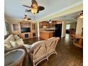 Open living space with hardwood floors and a large entertainment center, connecting to the kitchen at 217 Shore Loop, Winter Haven, FL 33884