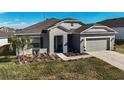 Lovely single story home with two car garage, manicured lawn, and tasteful landscaping at 516 Ingleside Ln, Haines City, FL 33844
