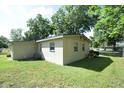 Spacious backyard with a well-maintained lawn, partial fencing, and plenty of room for outdoor activities at 520 Oakland Rd, Auburndale, FL 33823