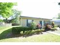 Cozy single-story home with blue shutters, green landscaping, and lush green lawn at 520 Oakland Rd, Auburndale, FL 33823