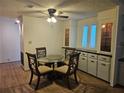 Cozy dining room featuring a round glass table and a built-in cabinet at 6685 Briarhill Dr Ne, Winter Haven, FL 33881