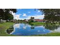Scenic pond view with a charming wooden bridge reflecting the blue sky at 7201 Country Club Dr # G21, Lake Wales, FL 33898