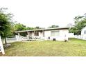Inviting home exterior with a covered porch and a neatly fenced yard at 7814 Plunkett Ave, Orlando, FL 32810