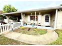 Charming front porch featuring seating, a Ring doorbell, and a well-manicured garden at 7814 Plunkett Ave, Orlando, FL 32810