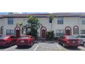 Building with multiple units, each with reserved parking spaces, decorative doors and tropical landscaping at 6294 River Run Pl # 193, Orlando, FL 32807