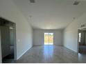 Bright and spacious living room with tile floors and sliding glass doors leading to the backyard at 2137 Emma Ln, Lake Wales, FL 33859