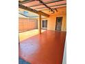 Covered patio with stained concrete, column supports, privacy fence, and secure access door at 1019 Grove St # 85, Maitland, FL 32751