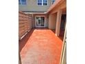 Spacious outdoor patio with stained concrete, privacy fence, secure door, and sliding glass door at 1019 Grove St # 85, Maitland, FL 32751