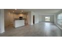 Spacious open-concept layout showcasing tile flooring, kitchen, and abundant natural light at 227 Bryce Ln, Frostproof, FL 33843