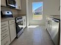 Well-equipped kitchen with stainless steel oven, dishwasher, and ample counter space at 216 Harper Estates Cir, Lake Wales, FL 33859