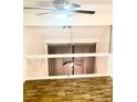 Loft area with a ceiling fan and a window covered by curtains at 6022 Peregrine Ave # B02, Orlando, FL 32819