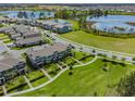 Community view showing townhome and surrounding lake at 16039 Juniper Inlet Aly, Winter Garden, FL 34787