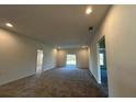 Spacious living room with carpet flooring and access to the backyard at 2177 Emma Ln, Lake Wales, FL 33859