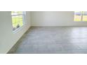 Bright living room with neutral tile flooring and lots of natural light at 2181 Emma Ln, Lake Wales, FL 33859