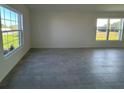 Bright living area featuring large windows offering ample natural light and views of the lawn at 2181 Emma Ln, Lake Wales, FL 33859
